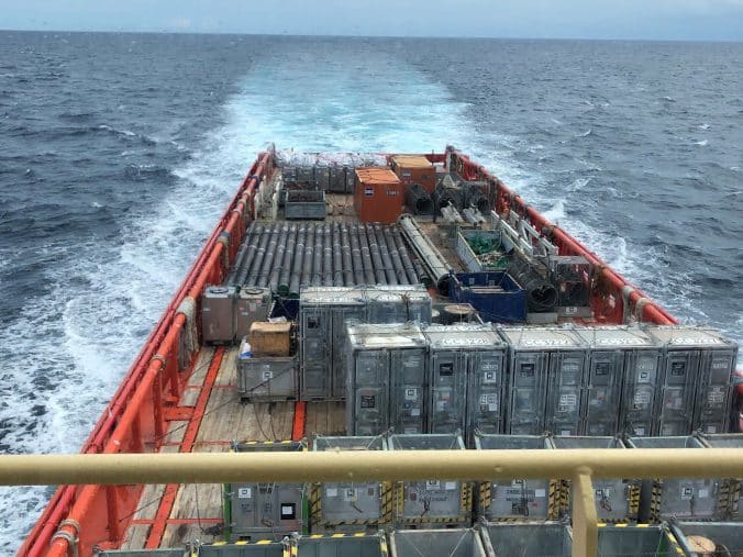 Cargo stacked up on a vessel at sea.