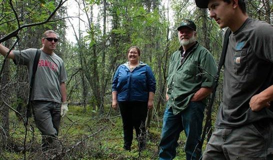 4 Ahtna workers and interns talking in the forest
