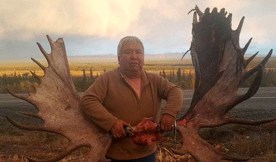 Photo of Ken Johns holding moose antlers