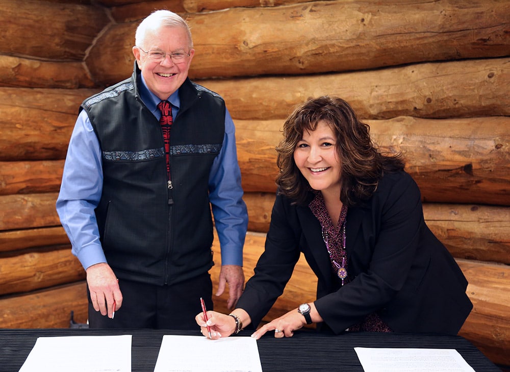 Here, Michelle and Alyeska President Tom Barrett sign the formal agreement
