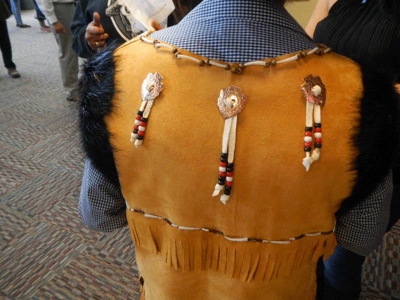 Photo of the back of John Craig showing hand made leather vest