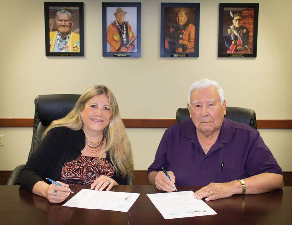 Chitina Native Corporation President Anne Thomas and Ahtna, Inc. Board Chairman Nicholas Jackson sign the agreement.