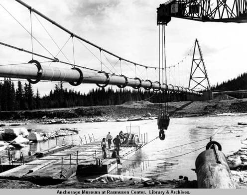 Black and white photo of Tazlina River and pipeline suspension bridge