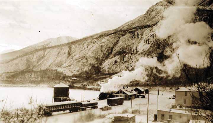 Sepia toned photo of The second to the last train leaves the Chitina Trail Depot. Photo courtesy of Alaska State Archives.