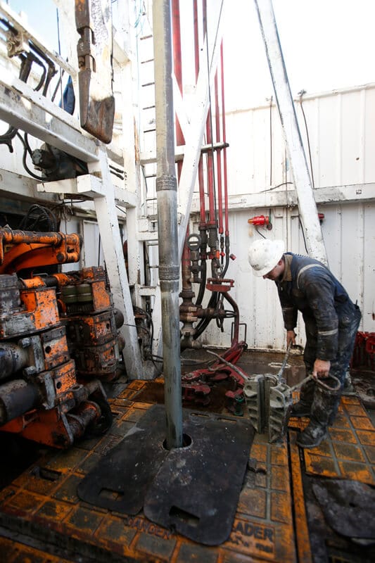 Tolsona Oil & Gass Exploration worker maintains a drilling rig.