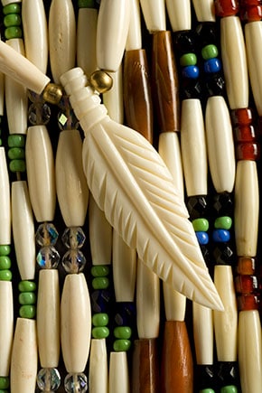 Close up of traditional Alaska native bead work with an ivory carved feather bead.