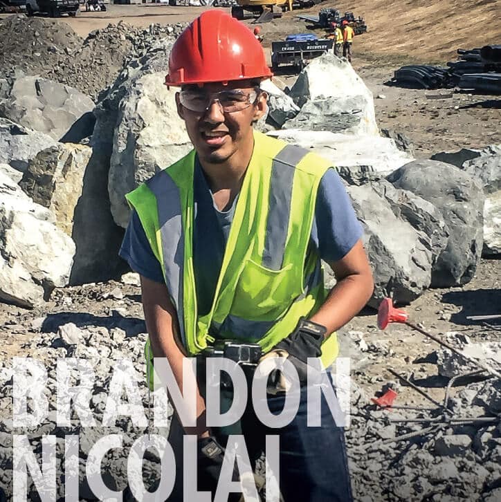 Brandon Nicolai wearing work uniform, smiling at camera