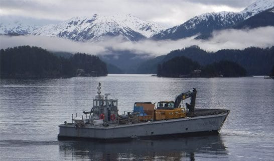 Photo of boat on the ocean in front of mountains