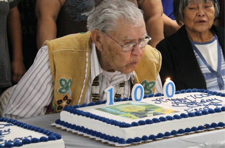 Chief Fred blowing cake candles 