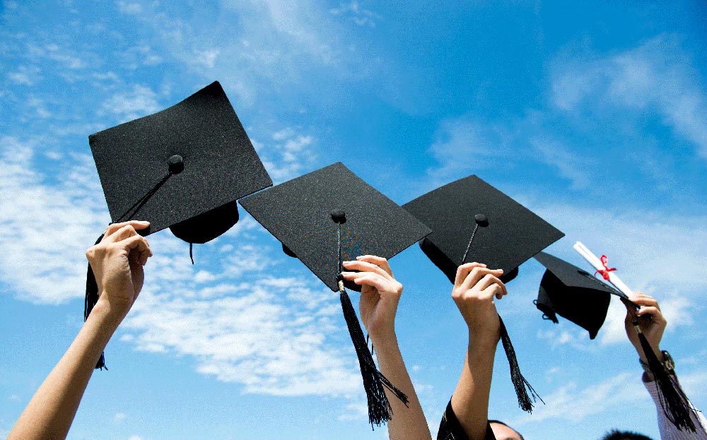 Photo of graduates holding their caps