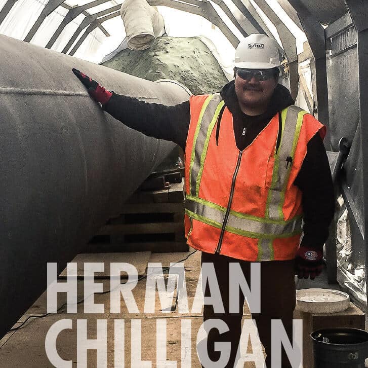 Herman Chilligan at work, smiling at camera