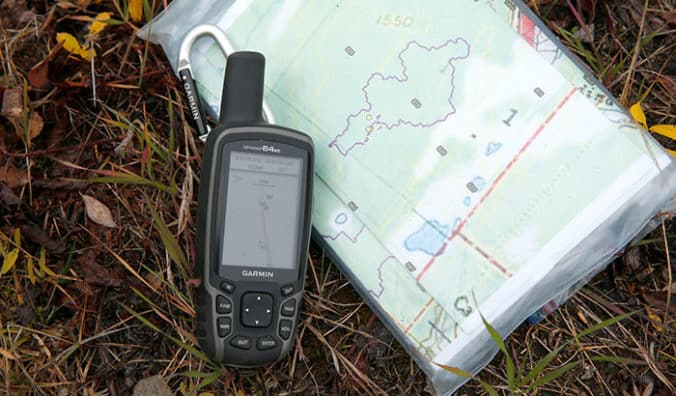 Garmin GPS device and map on the ground.