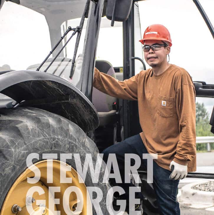 Stewart George at work, smiling at camera