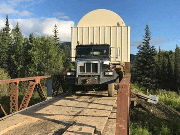 Construction truck driving over bridge