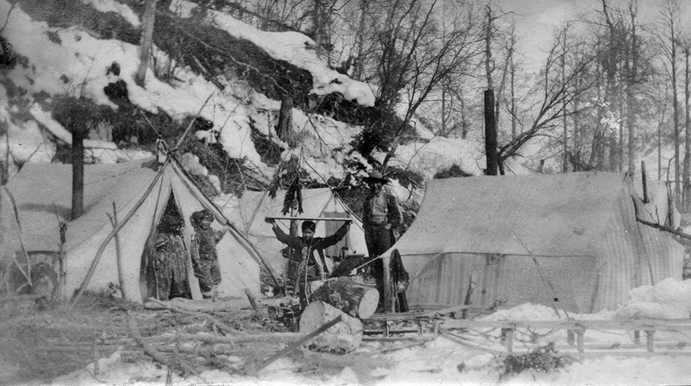 Old black and white photo of tents in the village